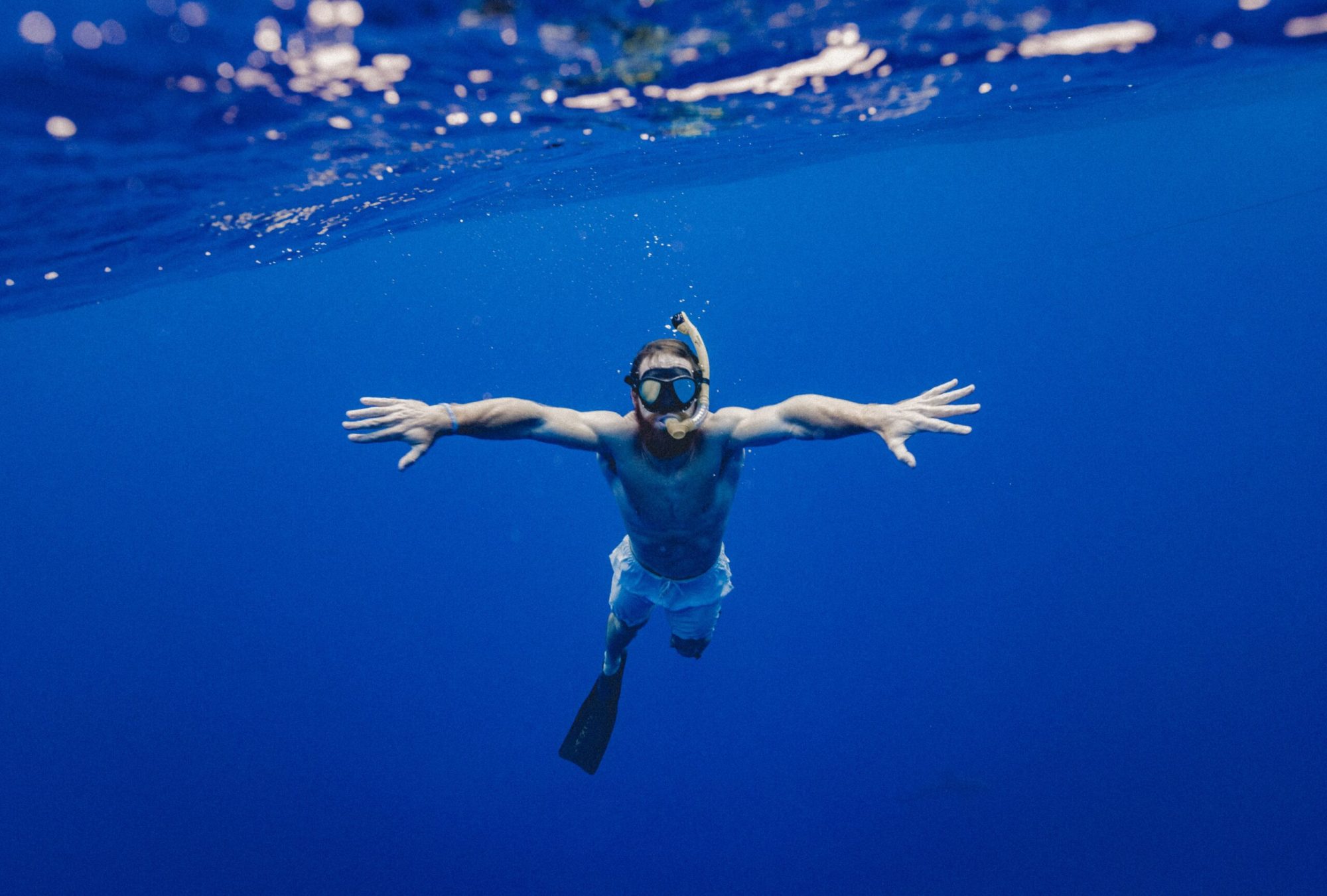 a person flying through the air while swimming in a body of water