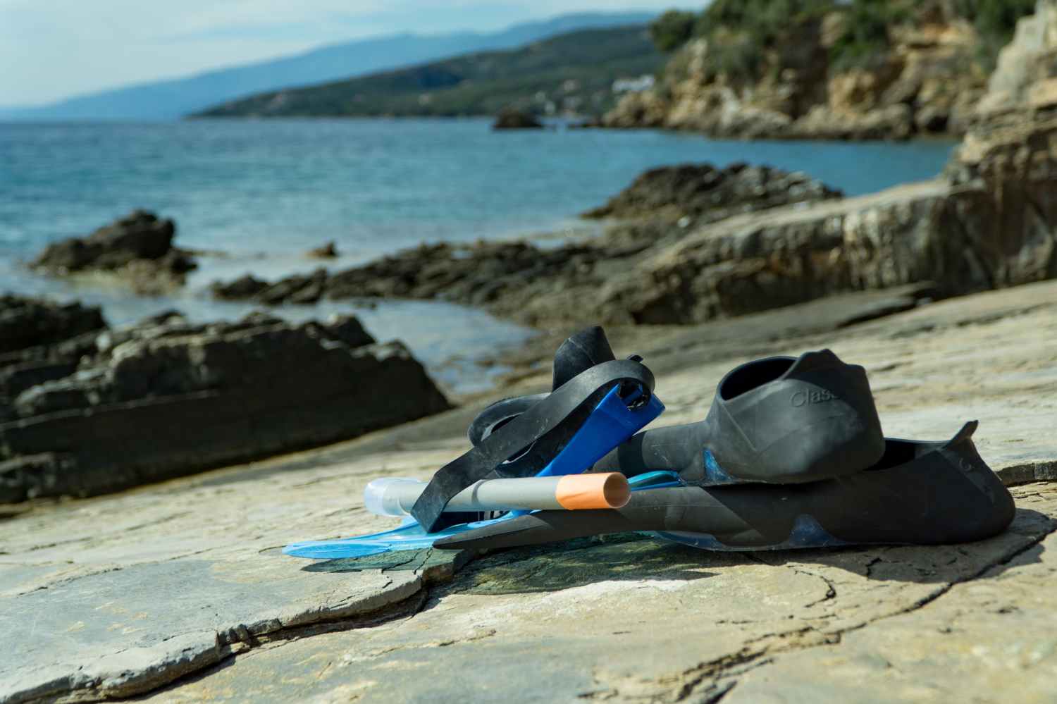 a close up of a sandy beach next to a body of water